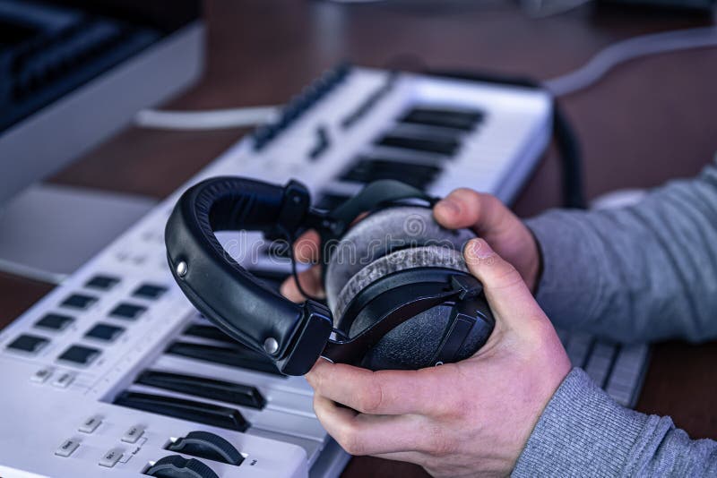Male Musician Creates Music Using Computer and Keyboard, Musician