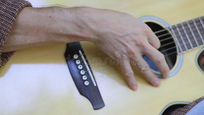 Male musician playing guitar outdoors