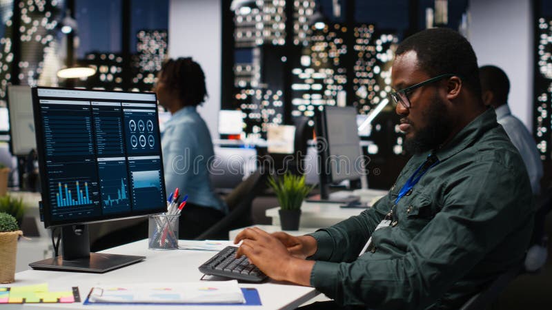 Male office worker using data and technology for business management, reviewing statement graphs on monitor to create reports and improve efficiency, objectives achievement. Vision. Reading efficiency stock images, royalty-free photos and pictures