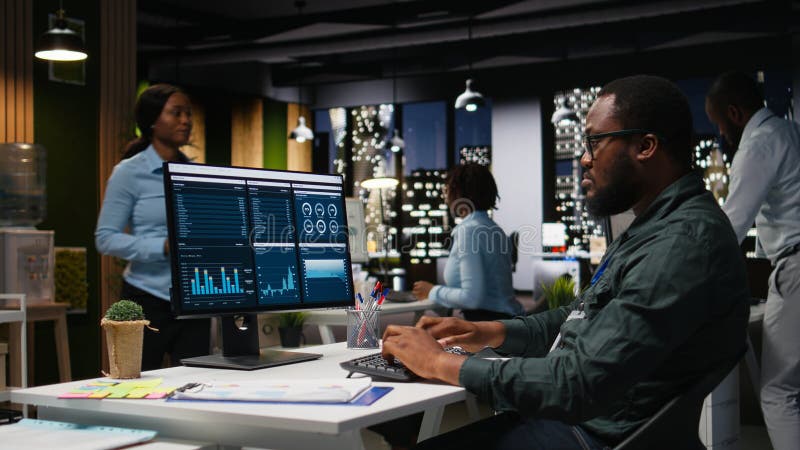 Male office worker using data and technology for business management, reviewing statement graphs on monitor to create reports and improve efficiency, objectives achievement. Vision. Reading efficiency stock images, royalty-free photos and pictures