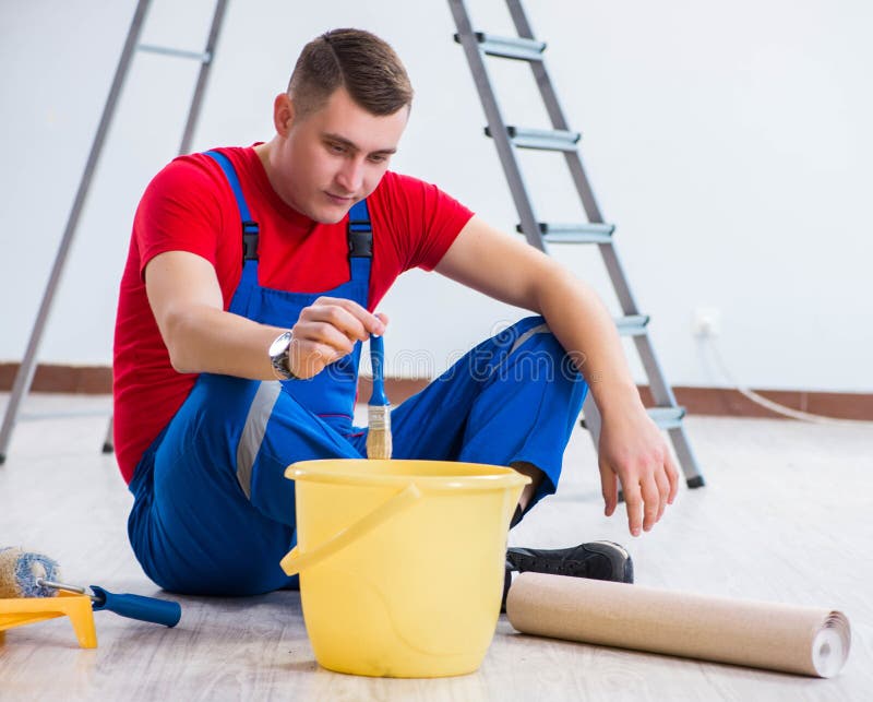 Male Painter Preparing for Painting Job at Construction Site Stock
