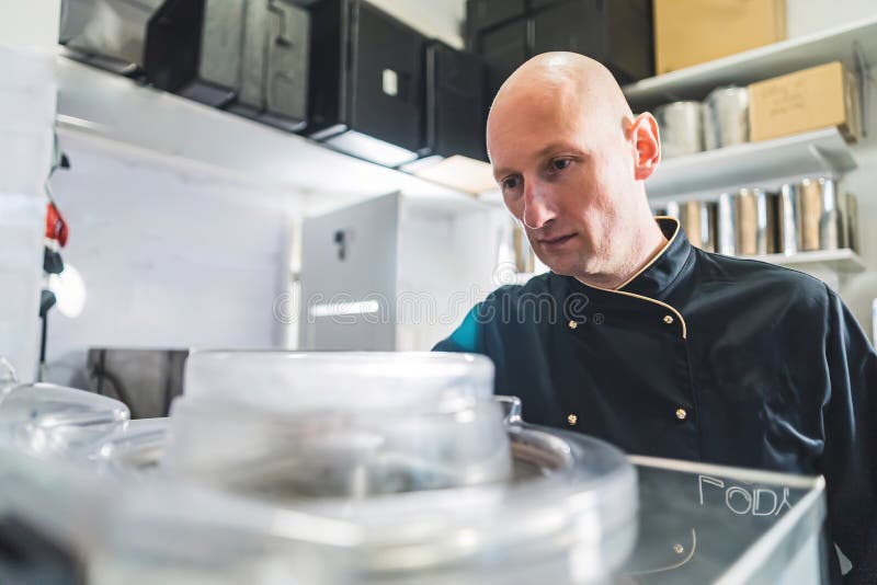 Male Pastry Chef Controlling Dairy Inside a Pasteurizer in a Production