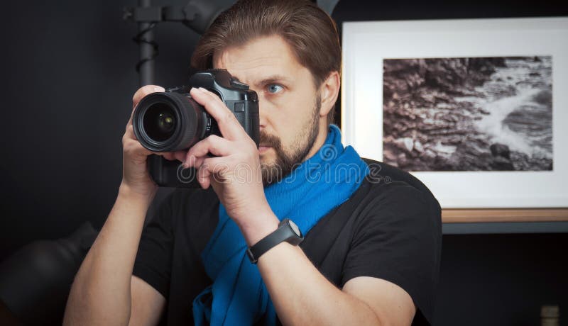 Male photographer taking pictures indoors stock image Male photographer taking pictures indoors stock image