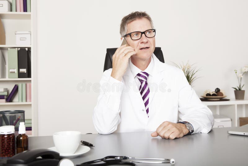 Male Physician Calling Client Through Phone royalty free stock photo Male Physician Calling Client Through Phone royalty free stock photo