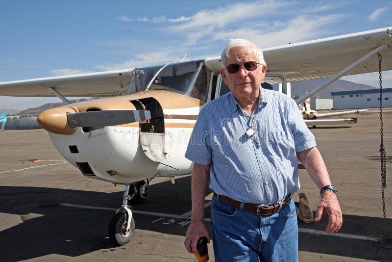 A senior citizen walks away from a private aircraft, a Cessna 172. A senior citizen walks away from a private aircraft, a Cessna 172.