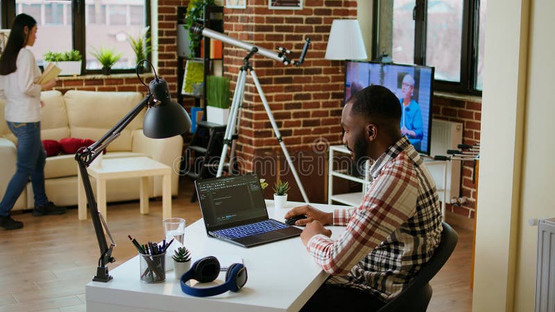 Male programmer developing an app on his laptop and working remotely stock images