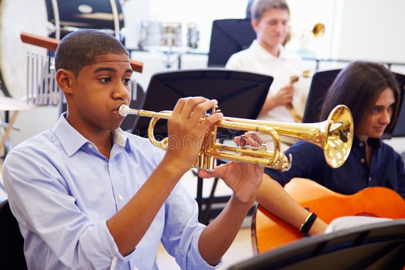 Male Pupil Playing Trumpet In High School Orchestra stock photography Male Pupil Playing Trumpet In High School Orchestra stock photography