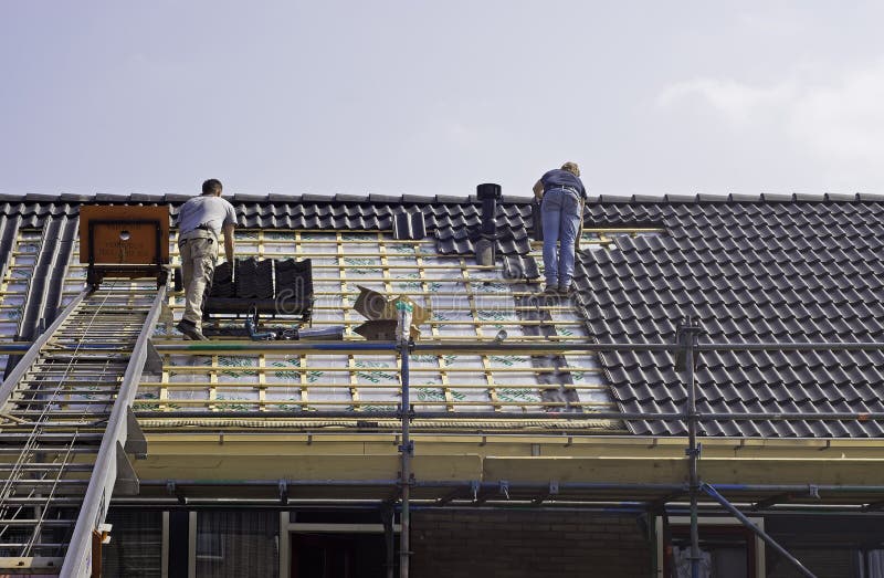Male roofers fitting tiles royalty free stock photos Male roofers fitting tiles royalty free stock photos