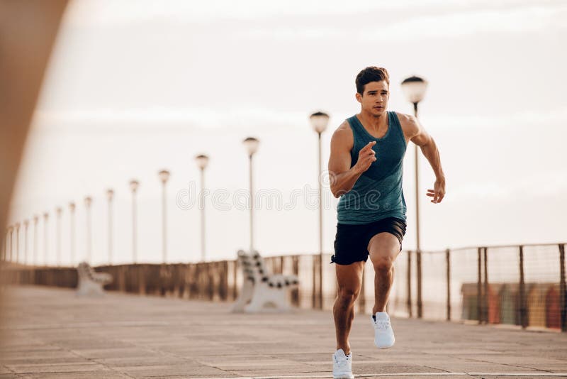 Male runner sprinting outdoors in morning royalty free stock photography Male runner sprinting outdoors in morning royalty free stock photography