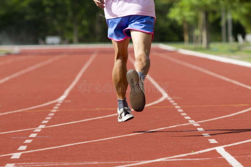 Male running at a track and field stock photo