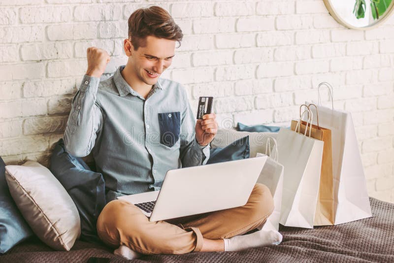 Male shopper celebrating sucessful shopping at online retail store