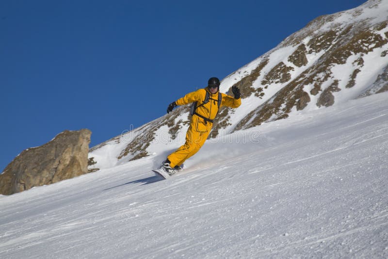 Male on snowboard on the slope of mountain