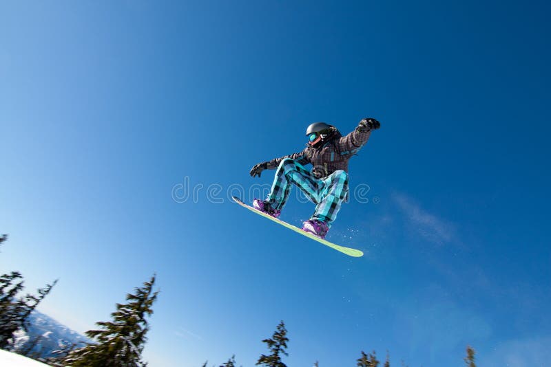 Male Snowboarder Catches Big Air on a Bright Sunny Day. Male Snowboarder Catches Big Air on a Bright Sunny Day.