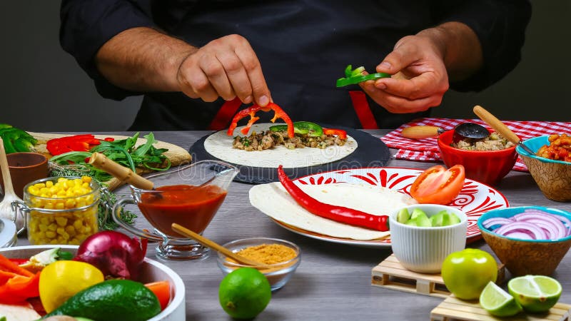 Male street vendor hands in gloves make taco. Mexican cuisine snacks, fast food of commercial kitchen royalty free stock photography Male street vendor hands in gloves make taco. Mexican cuisine snacks, fast food of commercial kitchen royalty free stock photography