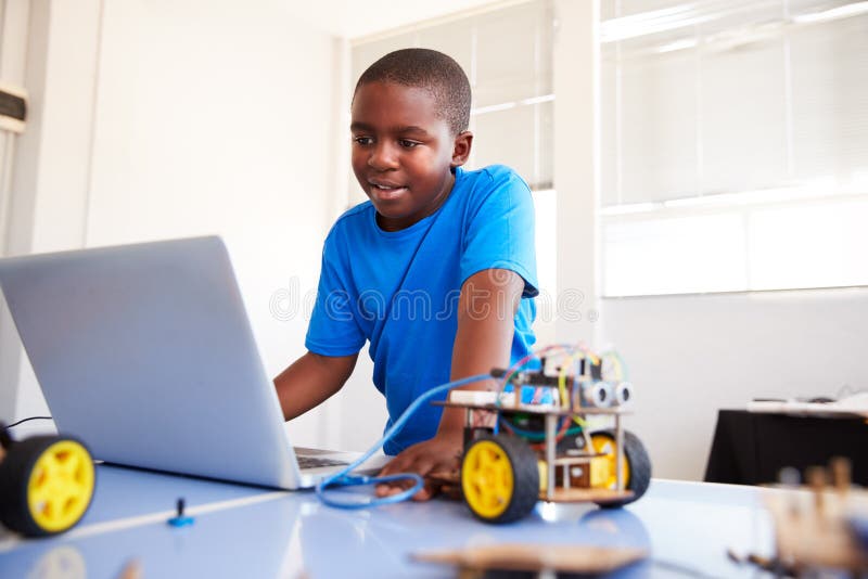 Male Student Building And Programing Robot Vehicle In After School Computer Coding Class royalty free stock images