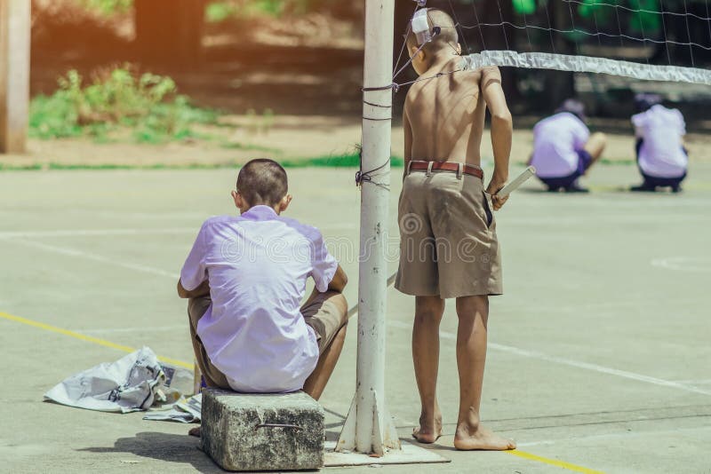 Male students use small paint rollers to paint yellow lines on the cement floor royalty free stock photos Male students use small paint rollers to paint yellow lines on the cement floor royalty free stock photos