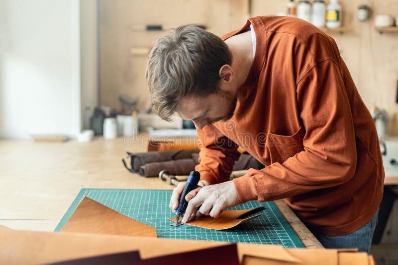 Male Tanner Making Cutting Scheme of Bag Working at Leather