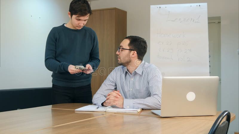 Male teacher take money from student for passing exam