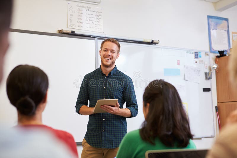 Male teacher using tablet computer at adult education class stock photos Male teacher using tablet computer at adult education class stock photos