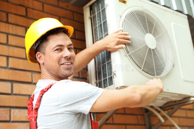 Man fixing air conditioner stock photo. Image of hands 28623748