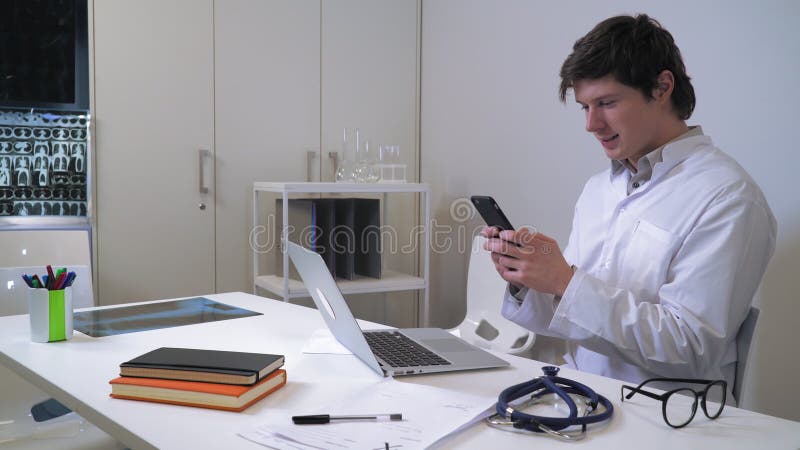 Male texting on mobile in hospital