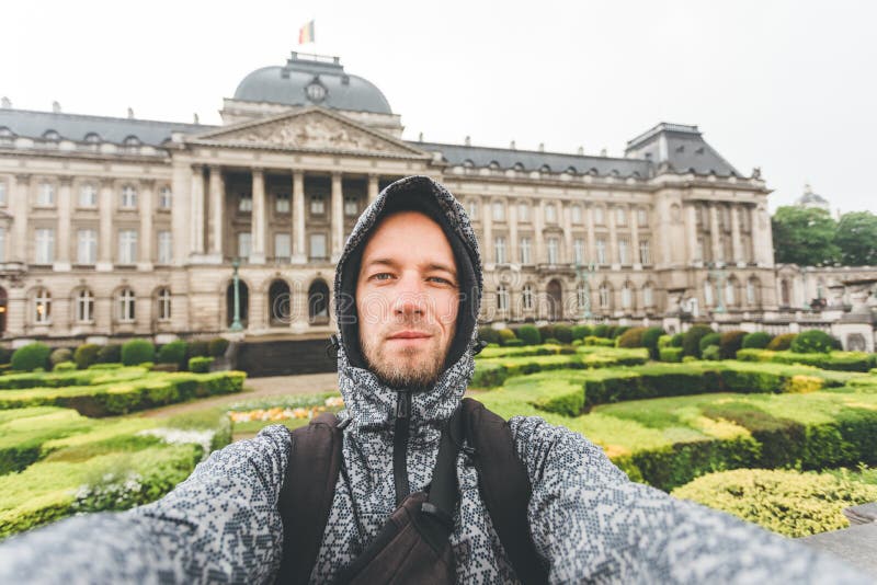 Male tourist takes selfie picture against the backdrop of the Royal Palace in Brussels, Belgium royalty free stock image Male tourist takes selfie picture against the backdrop of the Royal Palace in Brussels, Belgium royalty free stock image