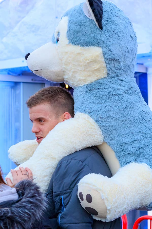A Male Tourist Walking with the Winning Prize Giant Plush Toy Dog on His  Shoulder at Christmas Funfair Winter Wonderland Editorial Photography -  Image of male, award: 191812602