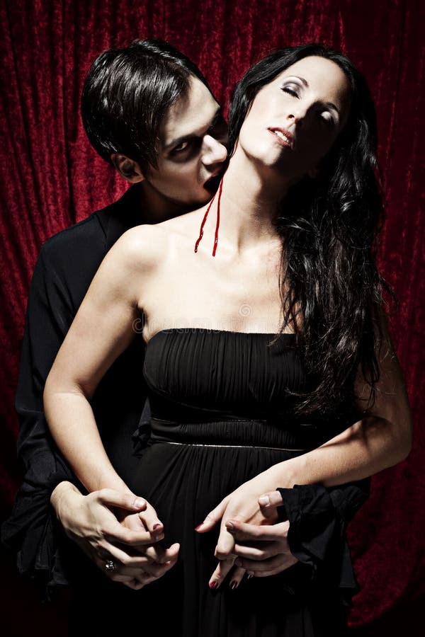 Male vampire is biting a woman with passion. 