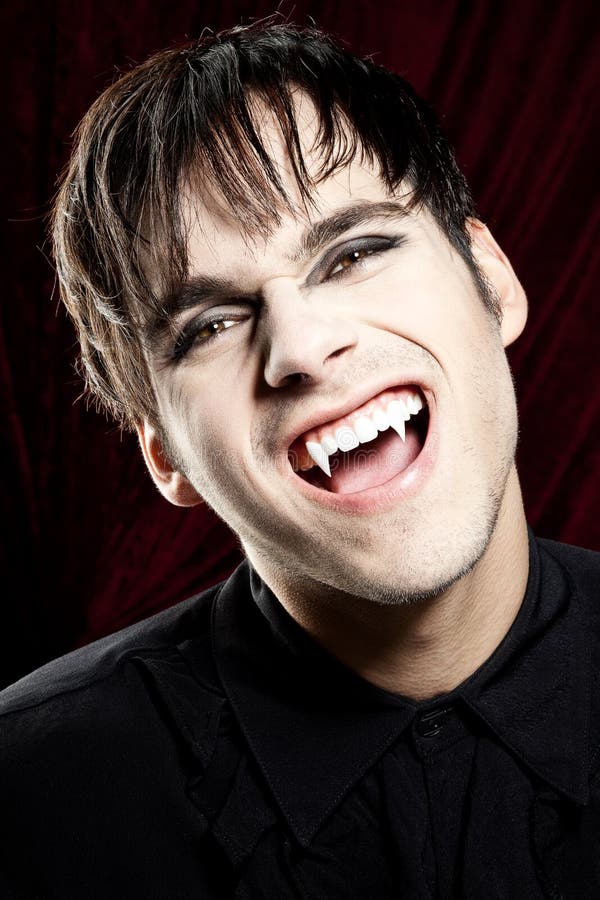 Male Vampire Smiling Dangerously, Showing Fangs Stock Photo - Image of ...