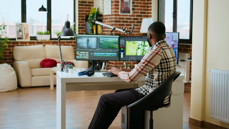 Male video creator edits a multimedia project at a modern office stock image