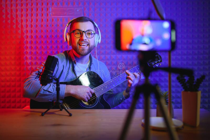 Male Vlogger Recording Music Related Broadcast at Studio Stock Image