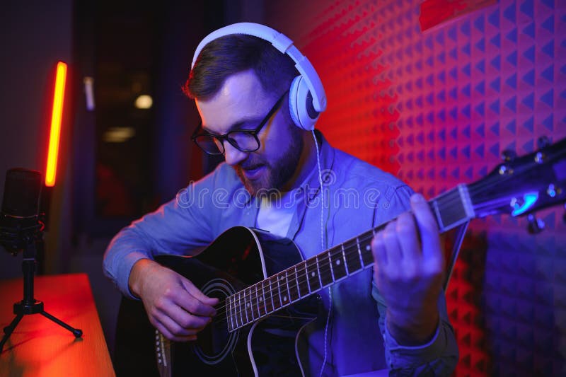 Male Vlogger Recording Music Related Broadcast at Studio Stock Image