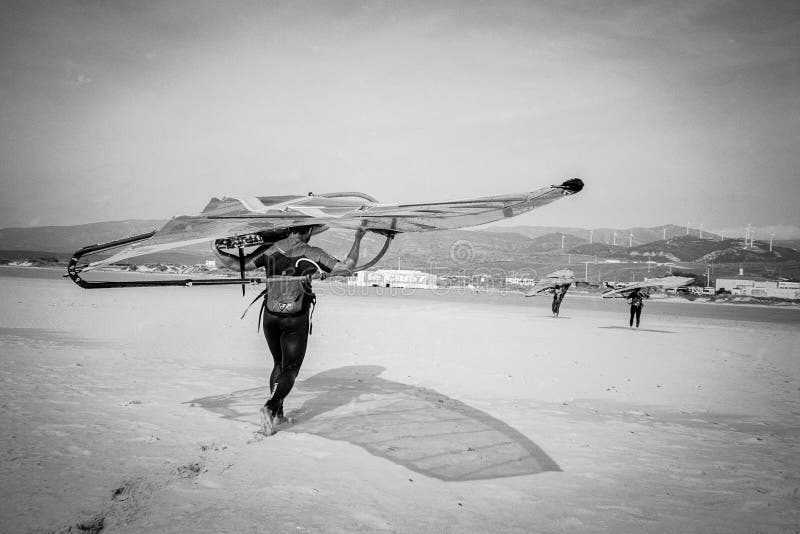 Windsurfer Carrying Board in Tarifa, Andalucia, Spain royalty free stock photography Windsurfer Carrying Board in Tarifa, Andalucia, Spain royalty free stock photography
