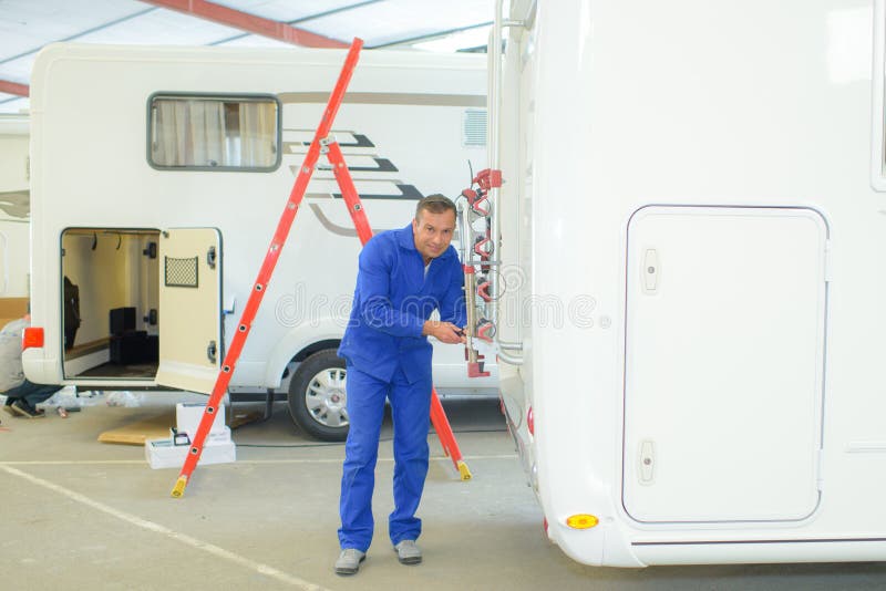 Male worker fixing caravan stock photo. Image of single 265994318