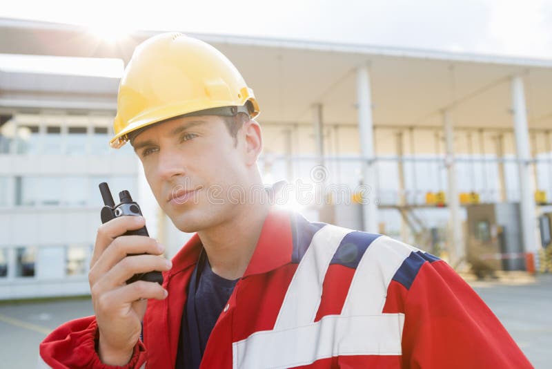 Male Worker Using Walkie-talkie in Shipping Yard Stock Image - Image of ...