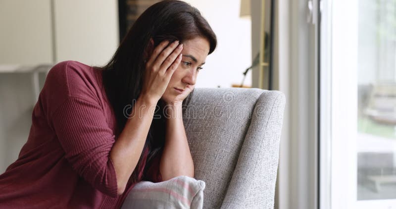 Malheureuse femme latine souffrant de mal de tête tenant la tête banque de vidéos