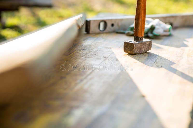 Mallet and builders level on a patio stock image