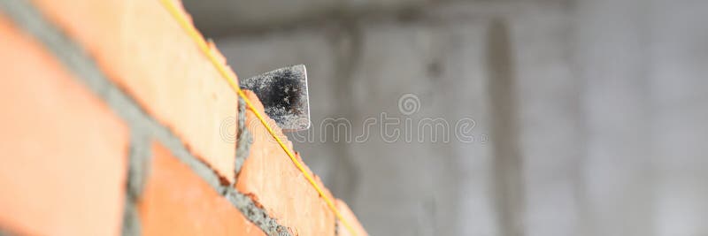 Mallet lying on top of brick wall as building and renovation stock images