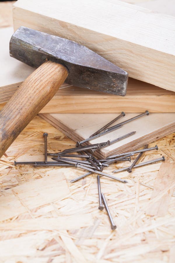 Mallet with nails and planks of new wood stock photography