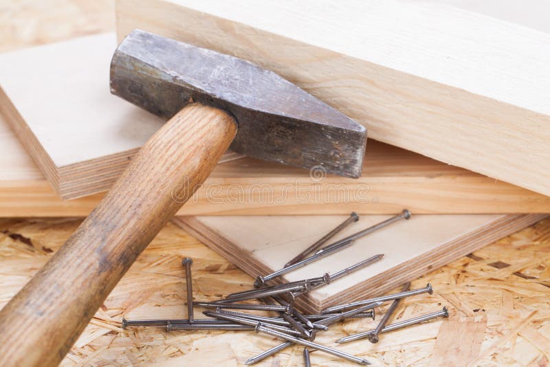 Mallet with nails and planks of new wood stock photos
