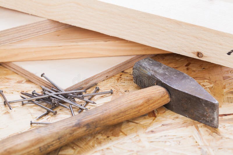Mallet with nails and planks of new wood stock photography