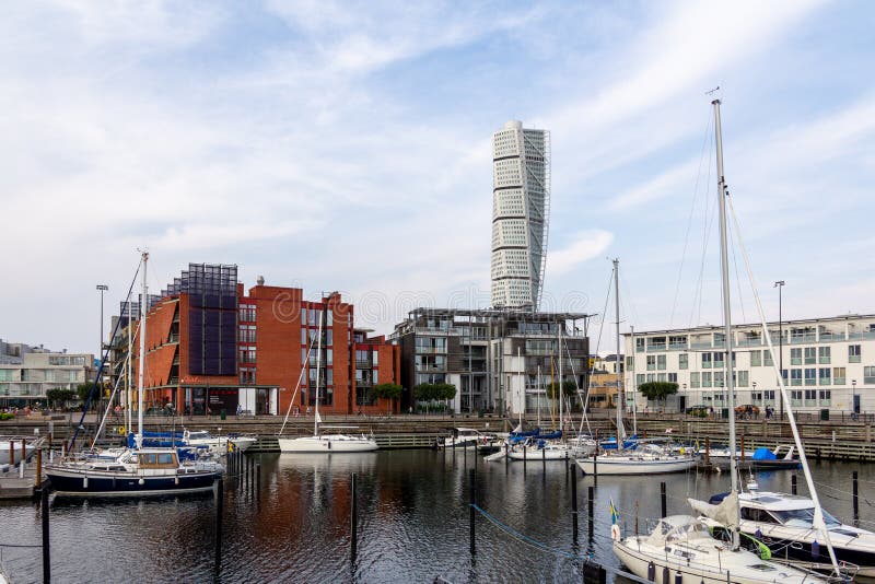 Malmö, Sweden - September 1, 2019: The marina in the area Västra hamnen Western harbor is still. Behind it the modern city is placed, with the skyscraper Turning Torso clearly visible. Malmö, Sweden - September 1, 2019: The marina in the area Västra hamnen Western harbor is still. Behind it the modern city is placed, with the skyscraper Turning Torso clearly visible.