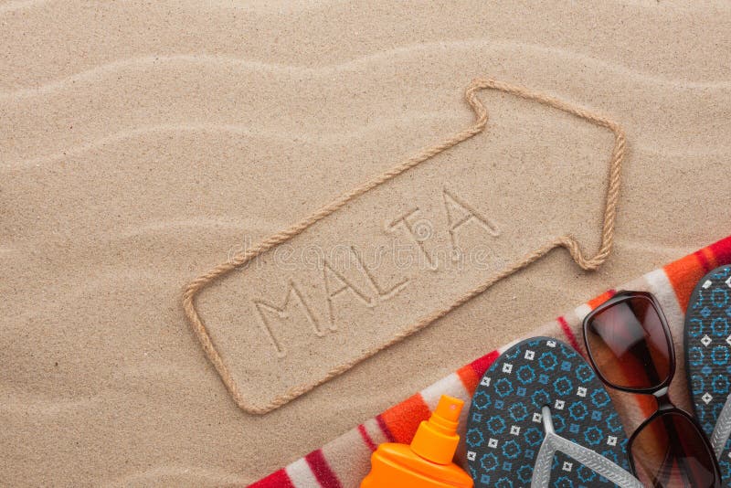 Malta Pointer and Beach Accessories Lying on the Sand Stock Photo