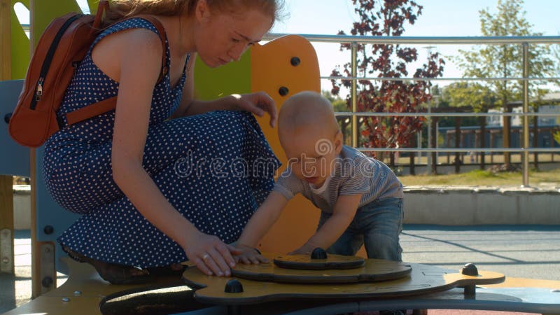 Mama playing with baby boy in the park stock images Mama playing with baby boy in the park stock images