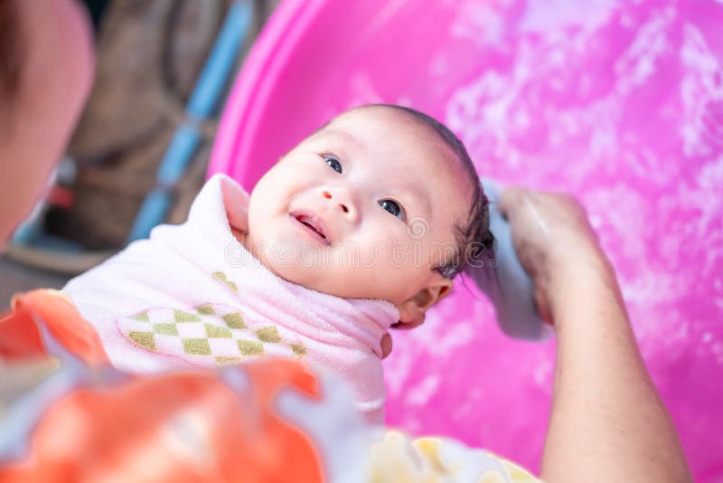 maman asiatique douche bébé pour nettoyer la saleté donner à l'enfant dans  le bain récipient pour la propreté mode de vie famille entre mère et enfant  utilisé pour la douche de bébé