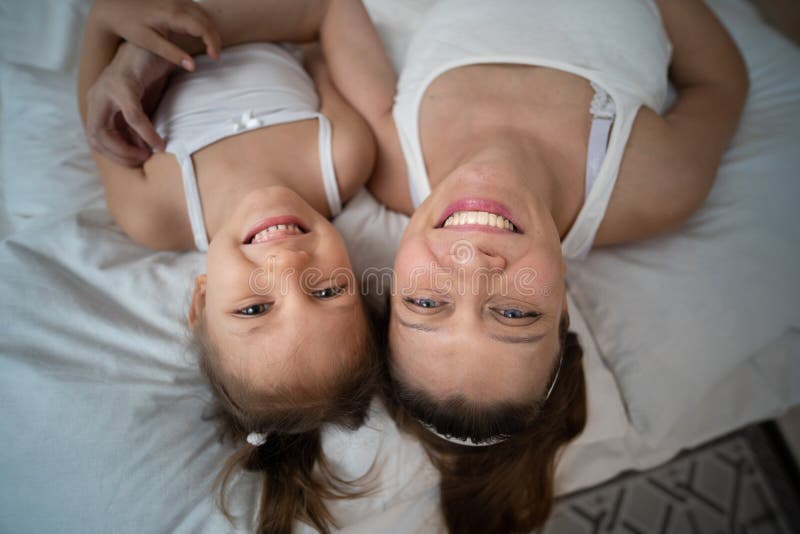 Mamma och dotter har kul i sovrummet arkivbilder