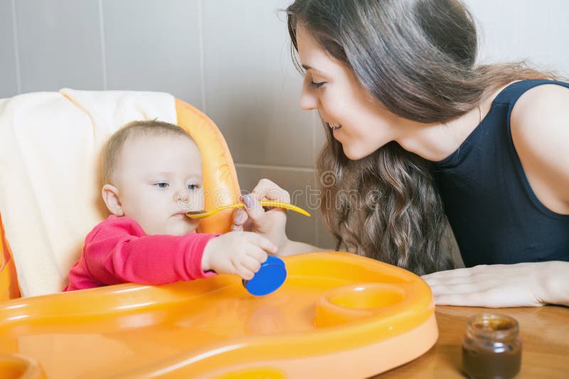 Mamman matar behandla som ett barnpurén Sunt och naturligt behandla som ett barn mat royaltyfri foto Mamman matar behandla som ett barnpurén Sunt och naturligt behandla som ett barn mat royaltyfri foto