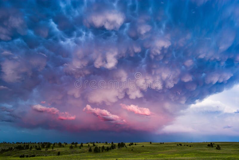 Mammatus clouds and stormy sky at sunset.