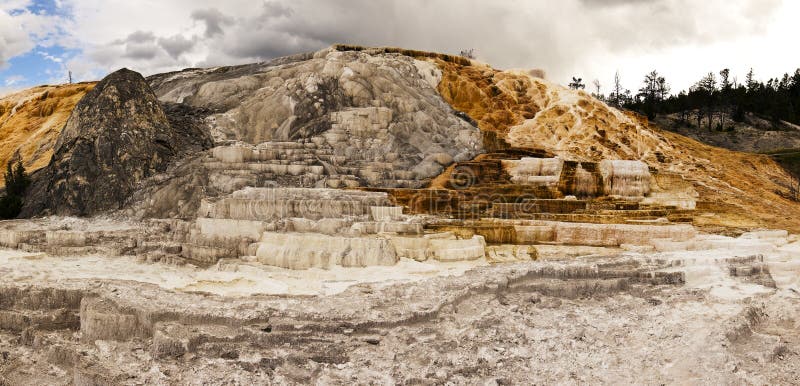 A view of one of the main features at Mammoth Hot Springs. The stone (travertine marble) is formed from the minerals in the water from the hot springs that have built up over years into a structure appearing like layers of a wedding cake. Wedding cone stock images, royalty-free photos and pictures