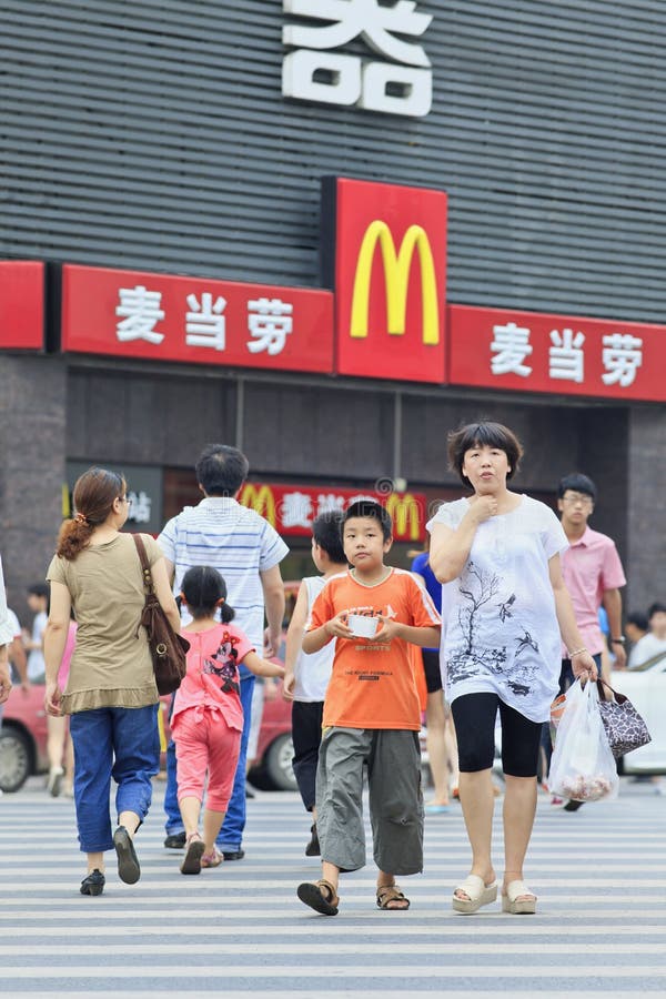 XIANG YANG-CHINA-JULY 3, 2012. Mom and her son in front of McDonalds on July 3, 2012 in Xiang Yang. It took McDonalds 19 years to reach 1,000 restaurants in China. It plans to have 2,000 by 2013. XIANG YANG-CHINA-JULY 3, 2012. Mom and her son in front of McDonalds on July 3, 2012 in Xiang Yang. It took McDonalds 19 years to reach 1,000 restaurants in China. It plans to have 2,000 by 2013.